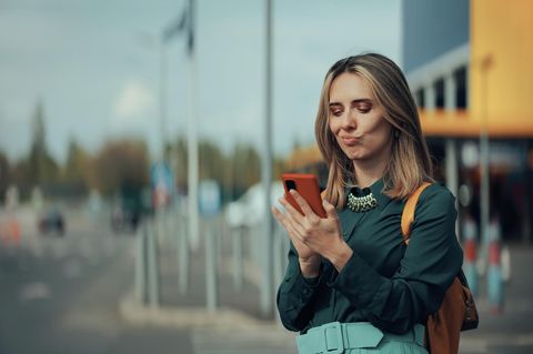 Eine Frau nutzt ihr Smartphone auf der Straße – nutzt sie einen Meta-Dienst?