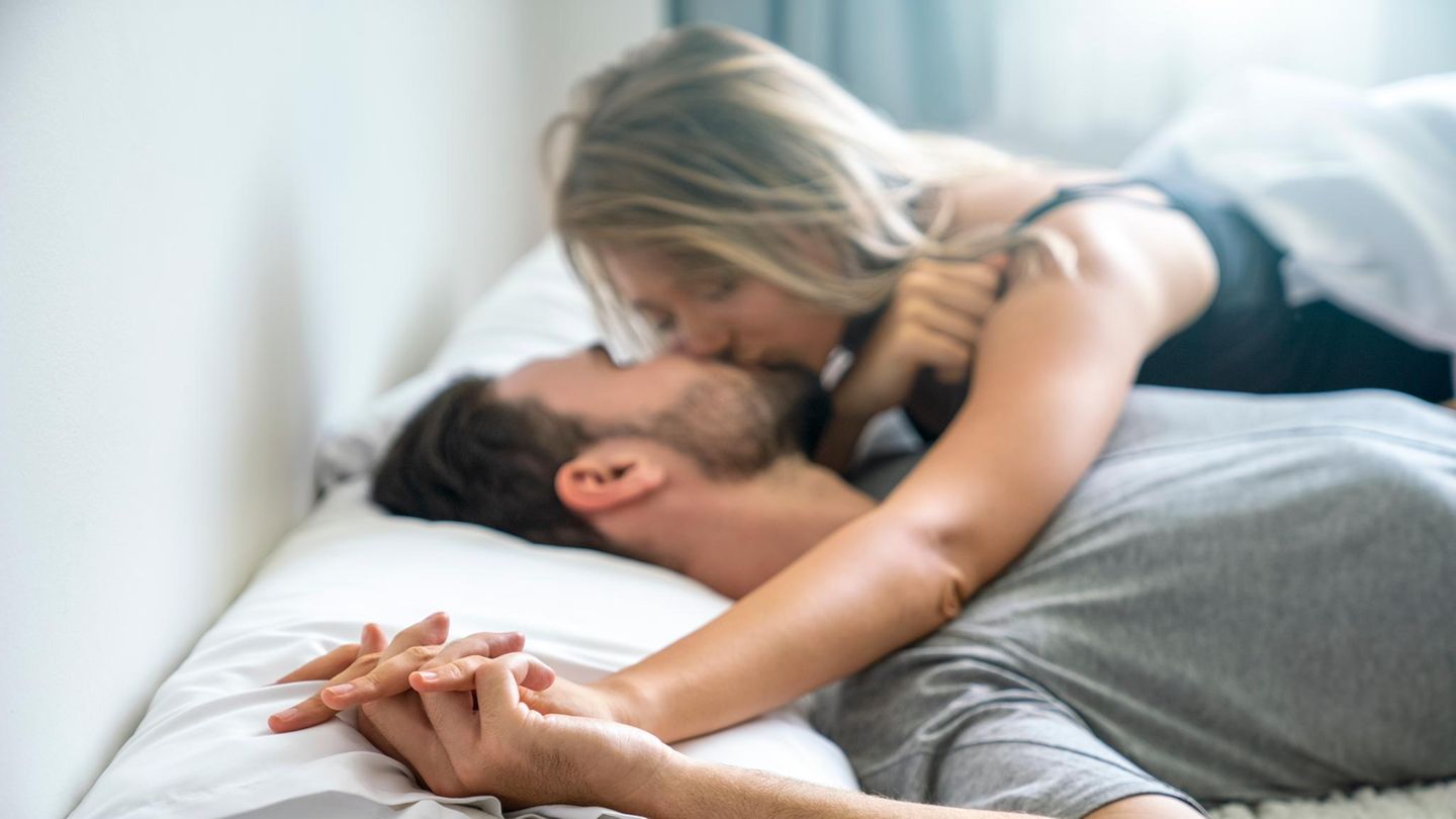 Affäre mit Anwalt Ein Liebespaar knutscht im Bett (Symbolbild Affäre)