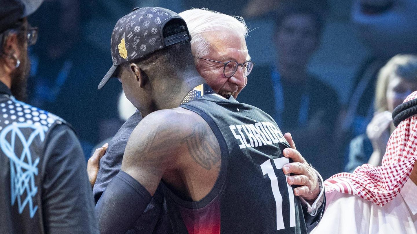 Bundespräsident Frank-Walter Steinmeier umarmt nach dem Finale Basketball-Kapitän Dennis Schröder