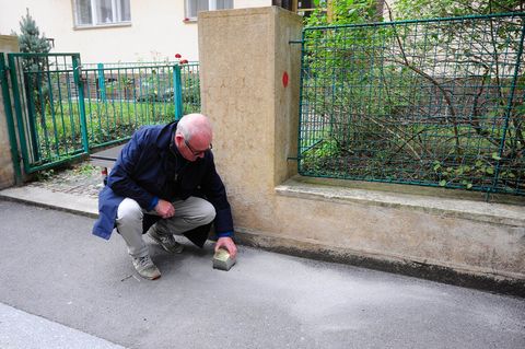 Gregory Tigrid hält den Stolperstein für seinen Vater Pavel Tigrid. In Prag erinnert vor dem Haus Kouřimská 5 ein neuer Stolpers