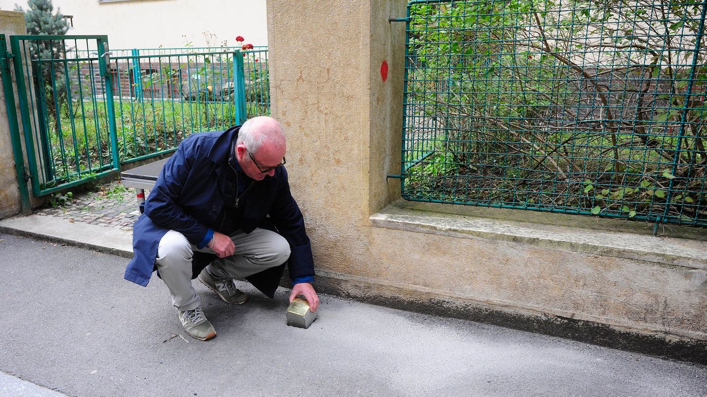Gregory Tigrid hält den Stolperstein für seinen Vater Pavel Tigrid. In Prag erinnert vor dem Haus Kouřimská 5 ein neuer Stolpers