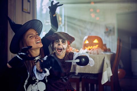Frau und Kind spielen an Halloween
