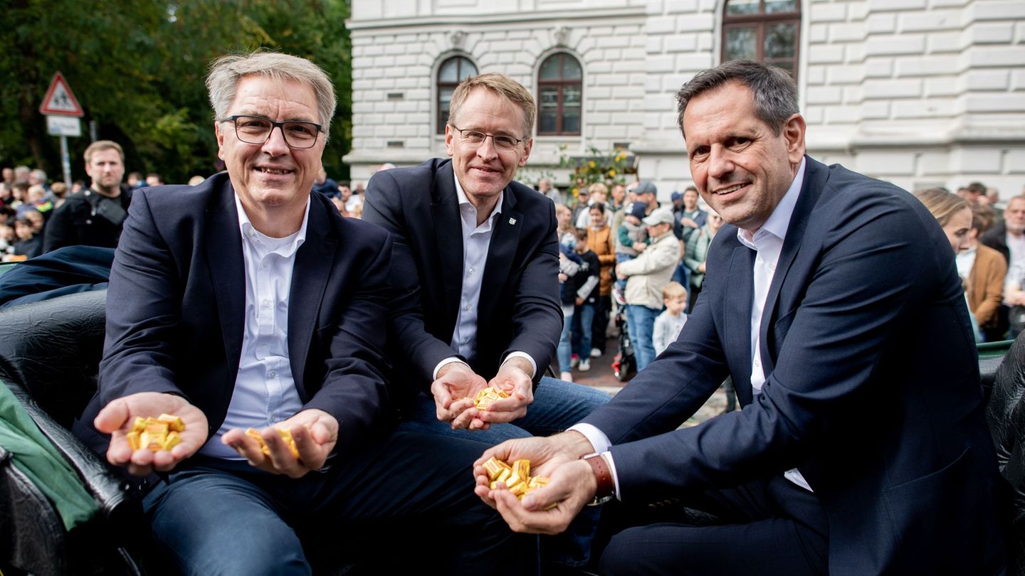 Oberbürgermeister Jürgen Krogmann (SPD) sowie die Ministerpräsidenten Daniel Günther (CDU) und Olaf Lies (SPD) sitzen in der Kut