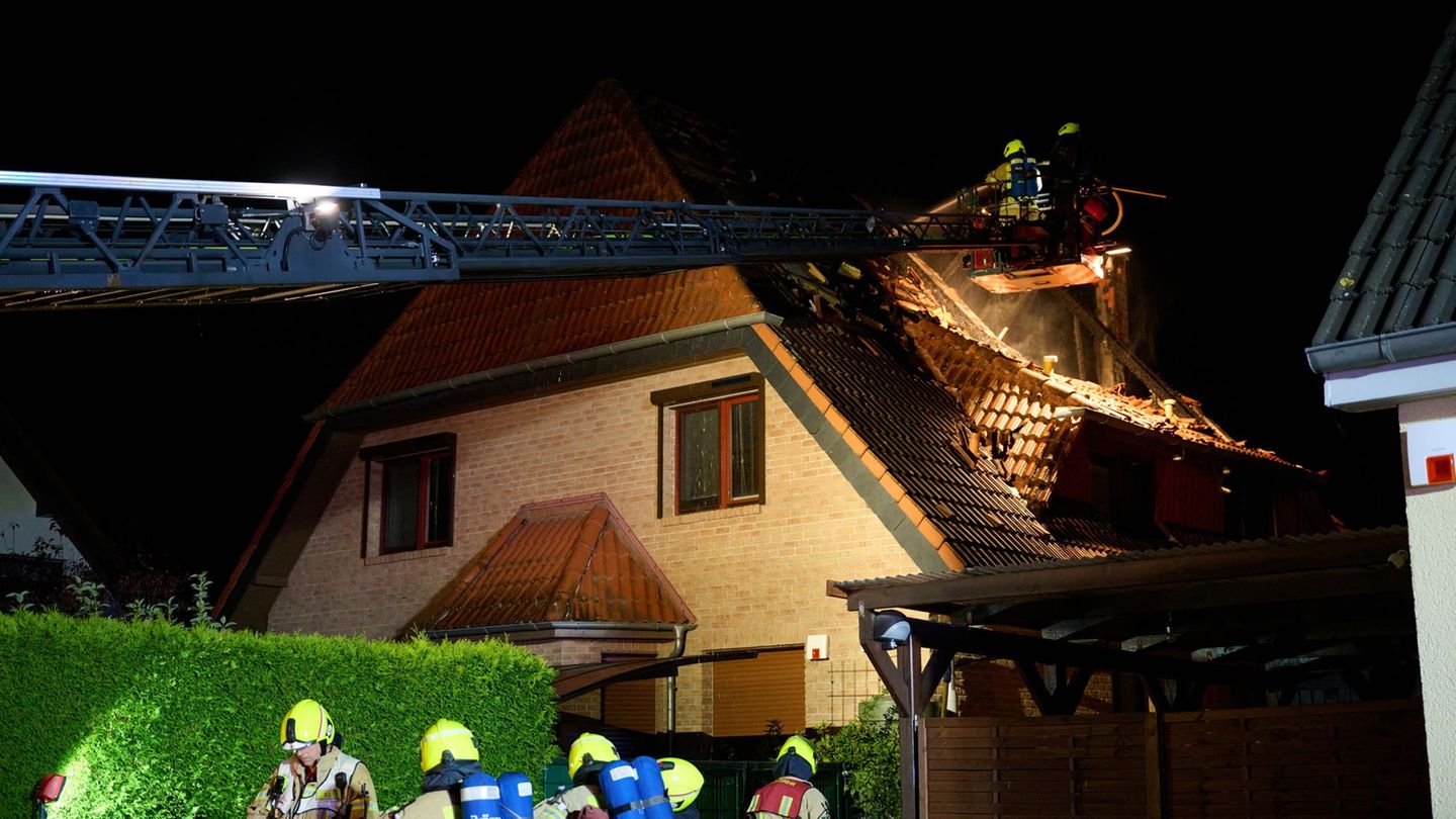 Einsatzkräfte der Feuerwehr stehen auf einer Feuerwehrleiter und löschen einen Brand in Marzahn. (Archivbild) Foto: Annette Ried