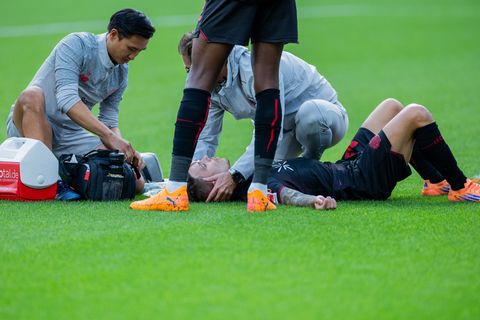 Bayer Leverkusens Kapitän Alejandro Grimaldo liegt nach einem Zusammenprall auf dem Boden. Foto: Rolf Vennenbernd/dpa