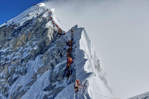Am Mount Everest gehen ein Bergsteiger nach dem anderen einen Grat entlang