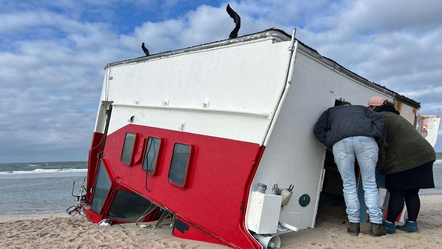 Schaulustige schauen sich auf Sylt einen angespülten Bootsaufbau an. Foto: Lea Albert/dpa