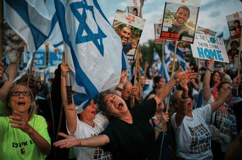 Israelis im Zentrum von Tel Aviv, sie halten Schilder und die Israelflagge hoch. Gaza Geiseln