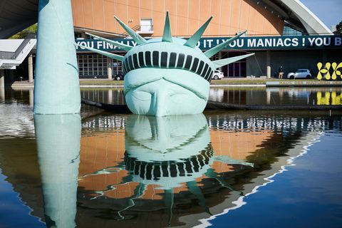 Böhmermann-Ausstellung: Der halbe Kopf einer aufblasbaren Freiheitsstatue, das Kunstwerk "Status of Liberty" liegt in dem Gewäss