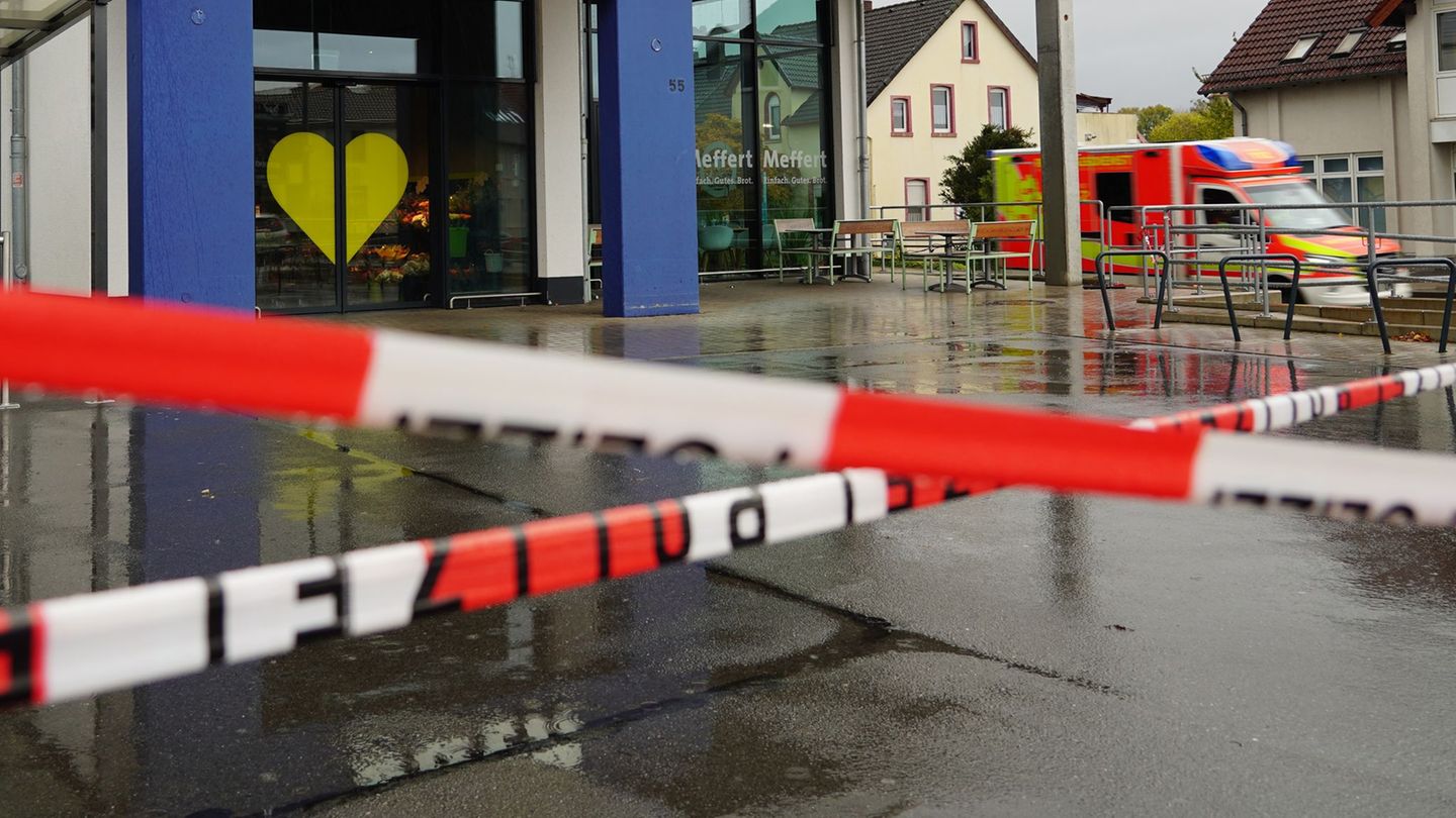 Die Polizei hat vor dem Supermarkt Absperrband angebracht, an der Seite steht ein Rettungswagen. Foto: Christian Müller/dpa