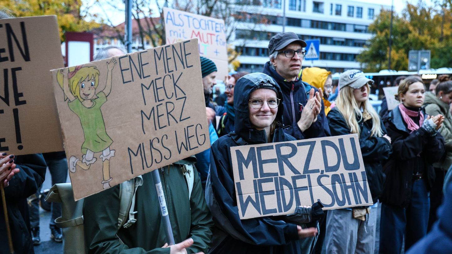 Ein Demonstrant hält ein Schild mit der Aufschrift "Merz, du Weidelsohn" hoch während einer Protestaktion nach den Aussagen von