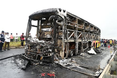 Die verkohlten Überreste des Passagierbusses liegen auf einer Landstraße im Dorf Chinnatekuru. Foto: -/AP/dpa