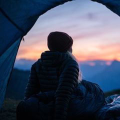 Hiker camps out in high mountain landscape