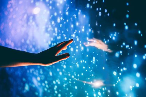 Eine Hand sucht Kontakt zur Hand eines Geistes (Symbilbild Tod).