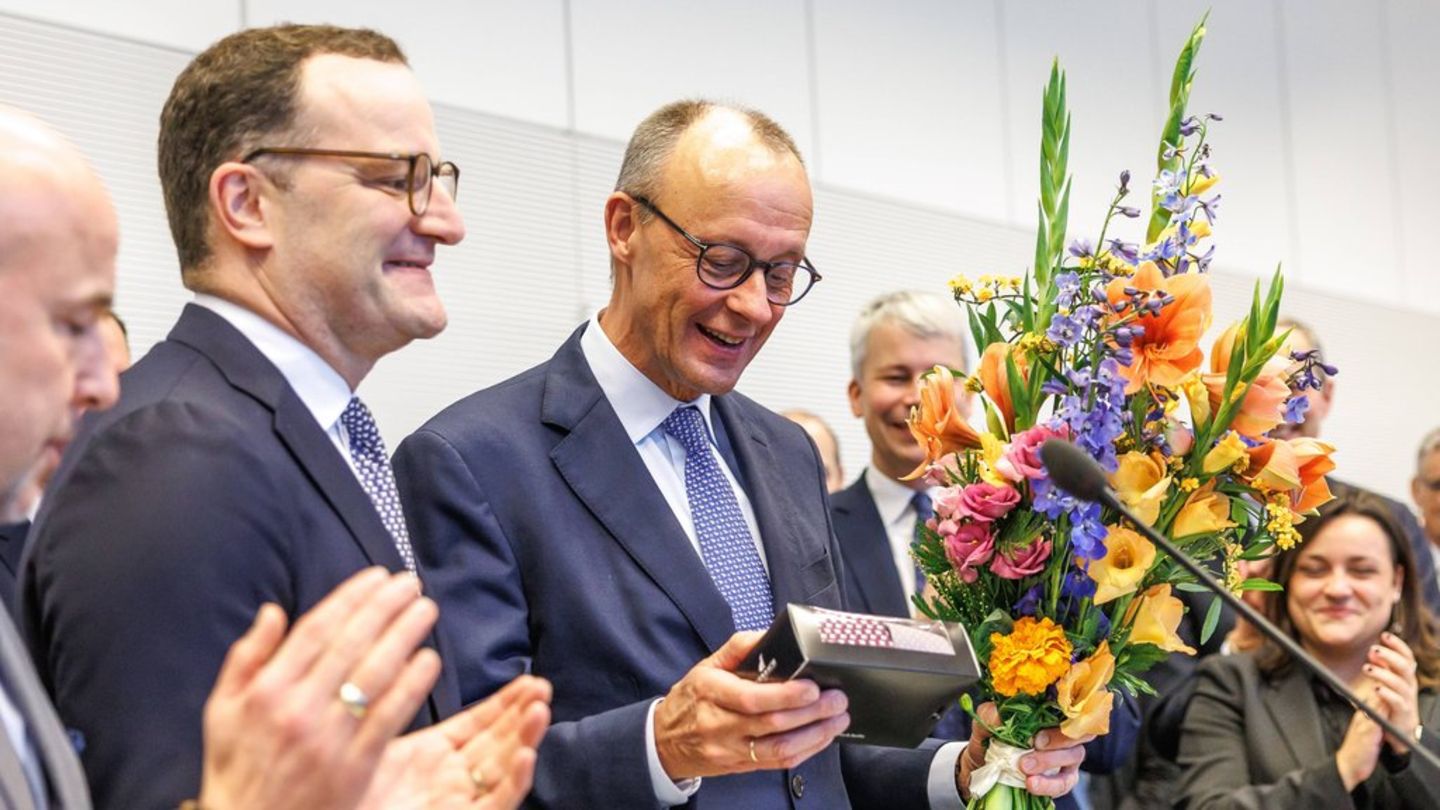 Jens Spahn (l.) überreicht Friedrich Merz zu seinem 70. Geburtstag neue Krawatten.