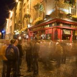 Verschwommene Menschenmenge vor einer roten Bar