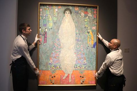 Zwei Mitarbeiter eines Auktionshauses hängen das Gemälde "Portrait of Elisabeth Lederer" von Gustav Klimt auf