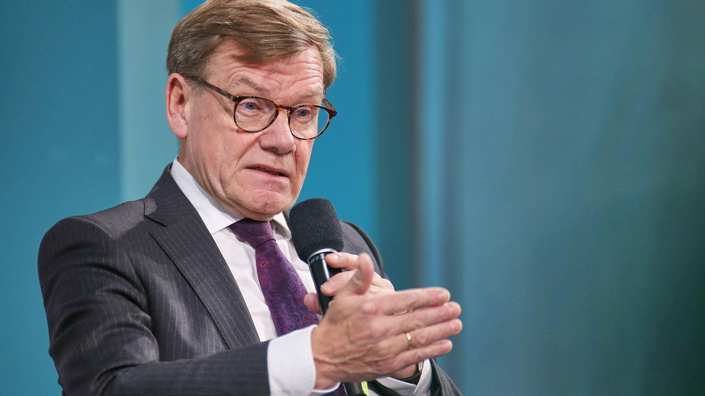 Johann Wadephul hält ein Mikrofon und schaut in die Kamera