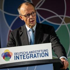 Friedrich Merz hält eine Rede am Pult der Deutschlandstiftung Integration