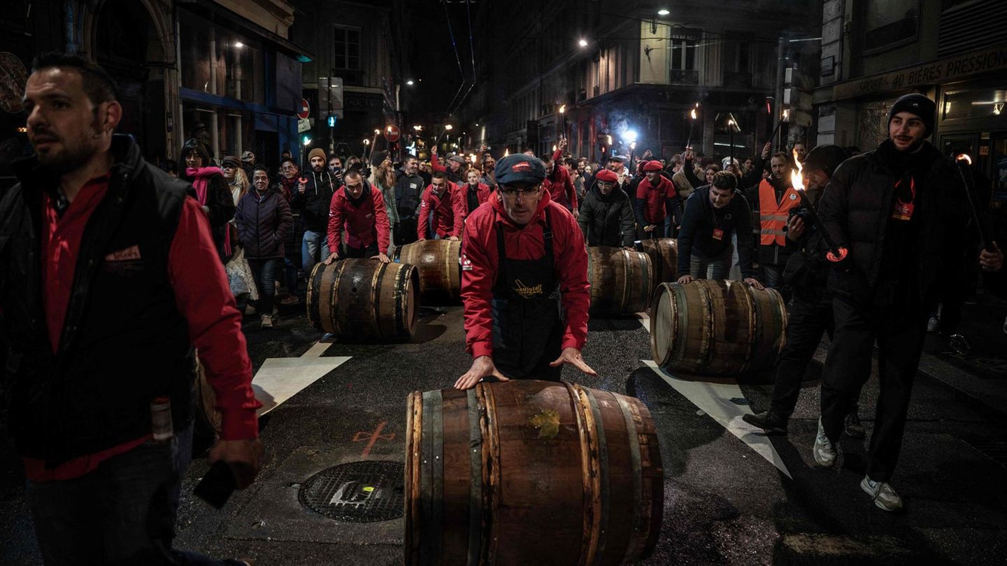 Lyon, Frankreich. Winzer rollen Fässer zum offiziellen Start der Ausgabe 2025 des Weins "Beaujolais Nouveau". Der erste Wein des laufenden Produktionsjahres aus der Gegend bei Beaujeu und Lyon geht traditionell am dritten Donnerstag im November in den Verkauf