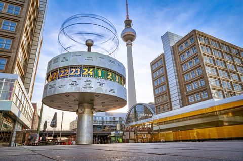 Long term exposure, panoramic view on the Urania World Clock in Berlin and TV Tower on the Alexander Square,  a tourist attraction and meeting place