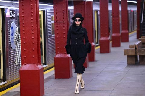 Ein Model läuft in der neuen Chanel Kollektion bei einer Modenschau durch eine New Yorker U-Bahnstation