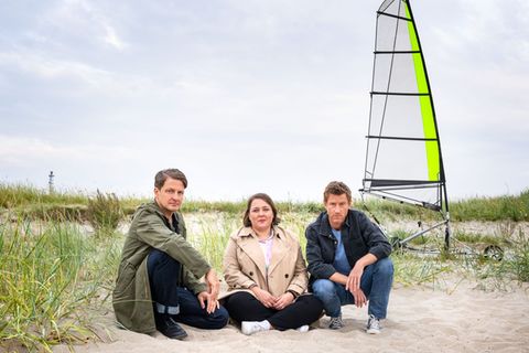 Bestatter Habedank (Holger Stockhaus, links) war gerade mit Melanie Harms (Tina Pfurr) unterwegs und beklagte sich, dass sich sein Schwarm Insa seit ihrem Umzug in die USA noch nicht bei ihm gemeldet hat, da stießen sie auf den tödlich verunglückten Dr. Momsen. Und die Hobbyermittler haben für Polizist Henk (Maxim Mehmet) auch gleich eine Theorie.