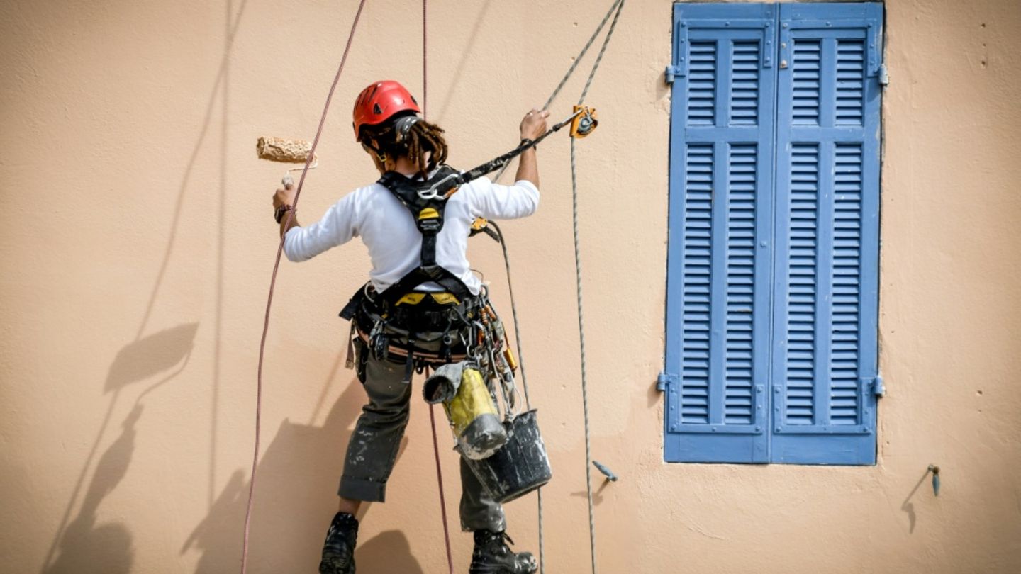 Anstreicherin an einem Haus