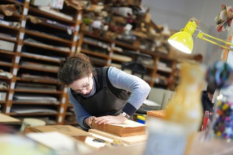 Buchbinderin Moiken Petong restauriert in der Werkstatt der Buchbinderei Fritz Castagne ein altes Buch. Foto: Marcus Brandt/dpa