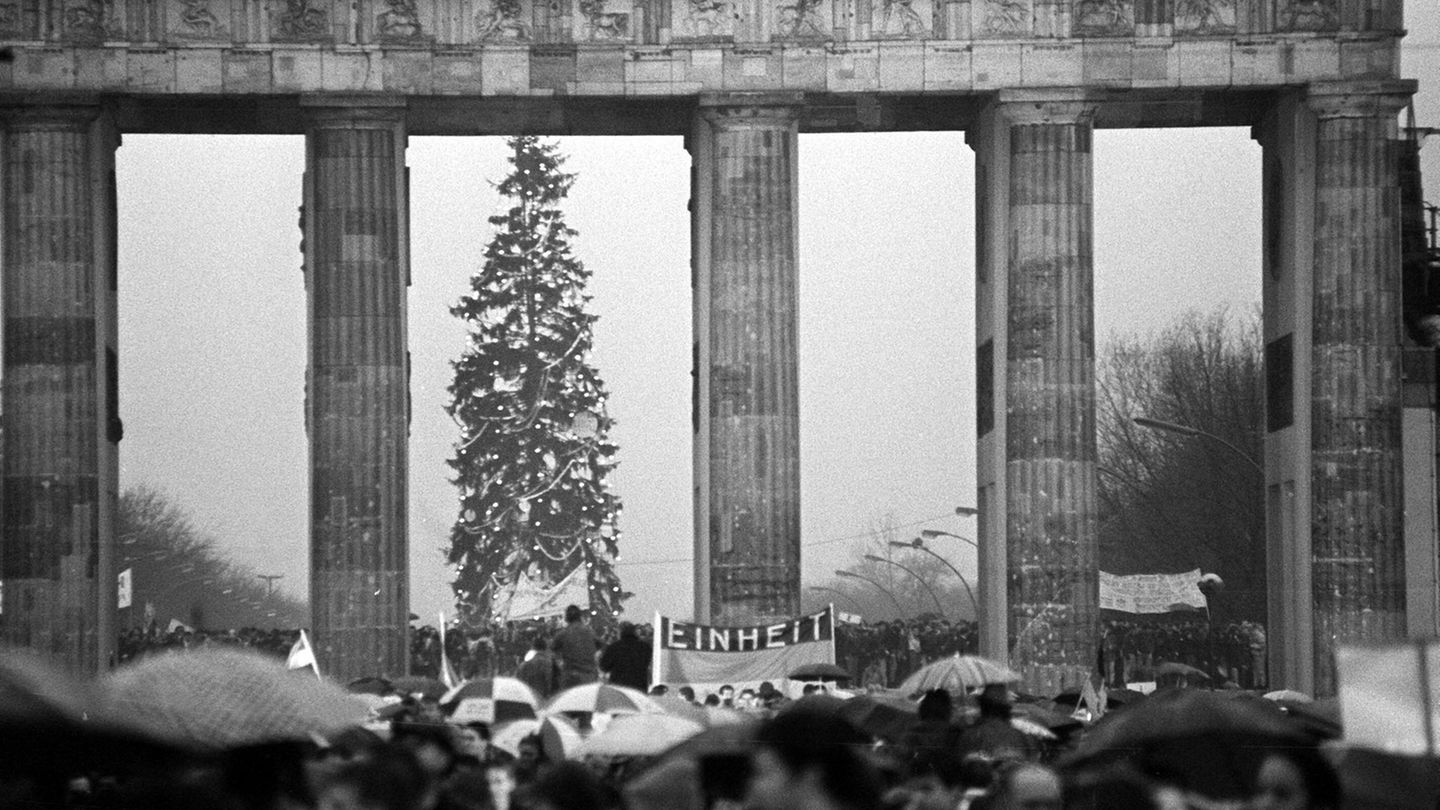 Am 22. Dezember 1989 drängen sich Menschenmassen um das Brandenburger Tor – der dortige Übergang ist erstmals geöffnet. Im Westen steht wieder ein Weihnachtsbaum, ein Jahr später ist Deutschland vereint