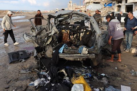 Palästinenser inspizieren den Ort eines israelischen Angriffs auf ein Auto in Gaza-Stadt