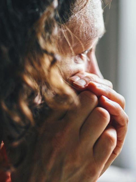 Eine Frau schaut nachdenklich aus dem Fenster. Ist sie auf Kreuzfahrt?