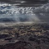 Noch durchbrechen einzelne Sonnenstrahlen die dichter werdende Wolkendecke und bestrahlen wie mit Scheinwerfern die karge, dystopisch anmutende Landschaft des namibischen Trockentals Huab. In ihrem Licht wirbelt der Staub eines aufziehenden Sandsturms. Er kündigt das sehnlich erwartete Gewitter an, das die ausgedörrte Landschaft mit seinem Regen zum Leben erwecken und die ausgetrockneten Flusstäler vorübergehend mit Wasser füllen wird. In der Regenzeit im Januar und Februar tummeln sich dann Wüstenelefanten und Nashörner am Ufer der Riviere – so nennt man in Namibia Flüsse, die nur zeitweise Wasser führen. Um sie herum werden Gräser, Kräuter und Wildblumen sprießen, deren Samen monate- oder gar jahrelang in der Erde schlummerten und auf ihren Einsatz warteten