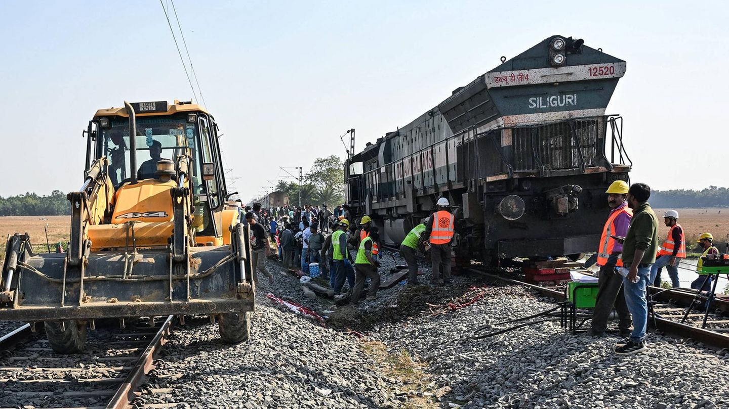 Indien: Die Unfallstelle im indischen Bundesstaat Assam: Bahnarbeiter kümmern sich um die entgleiste Lokomotive