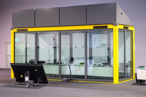 Blick auf den leeren Glaskasten im Gerichtssaal des temporären Gerichtsgebäudes vom Landgericht Magdeburg, in dem normalerweise