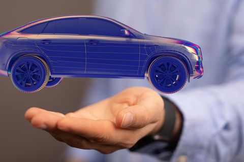 Ein Auto schwebt in einer Hand (Symbolbild Führerscheinquiz)