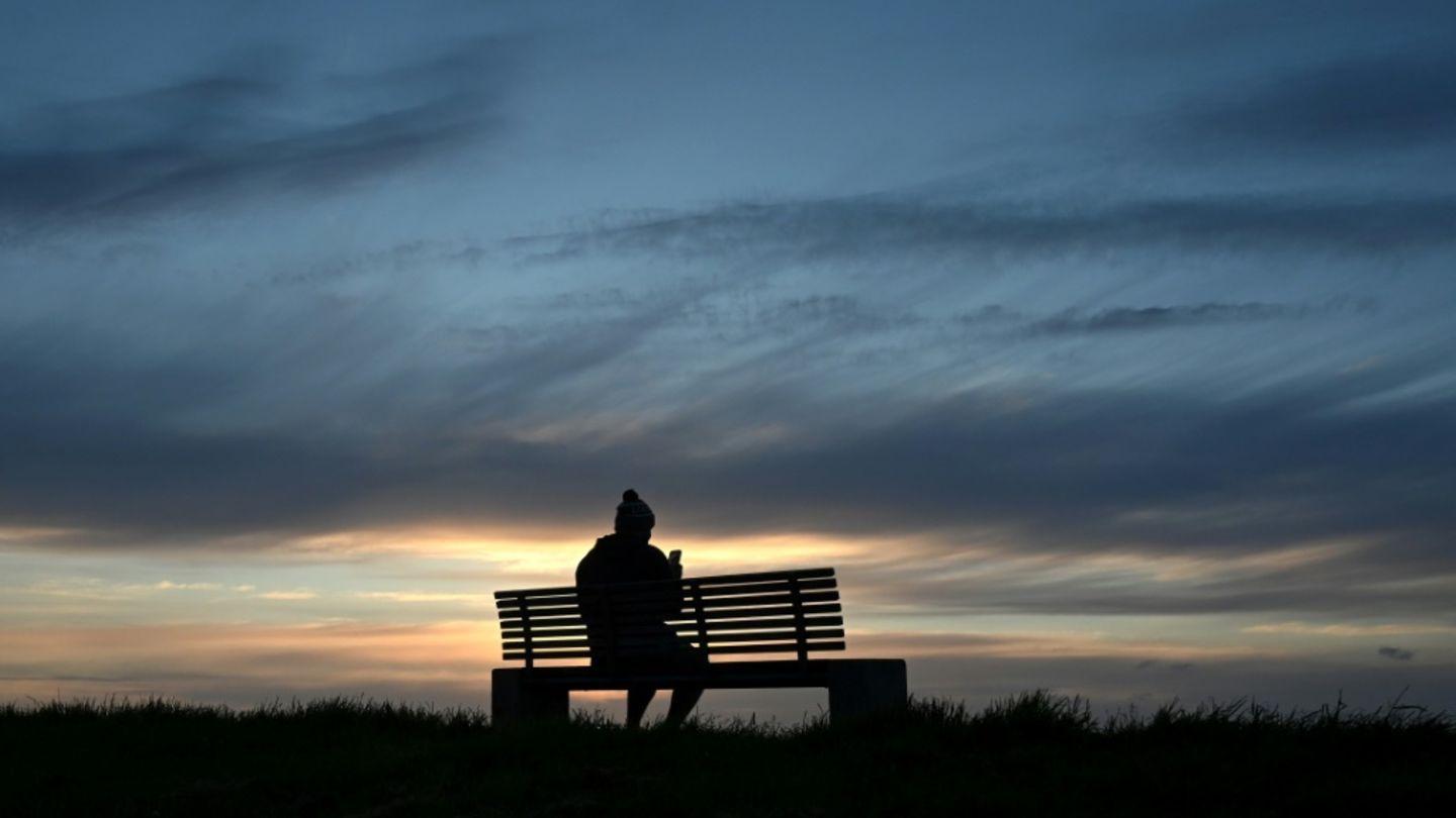 Mann auf einer Bank an der Nordsee