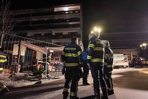 Rettungskräfte der Feuerwehr am abgesperrten Unglücksort vor der Bar "Le Constellation" in der Schweiz