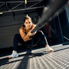 Eine sportliche junge Frau bei einer Hyrox Übung