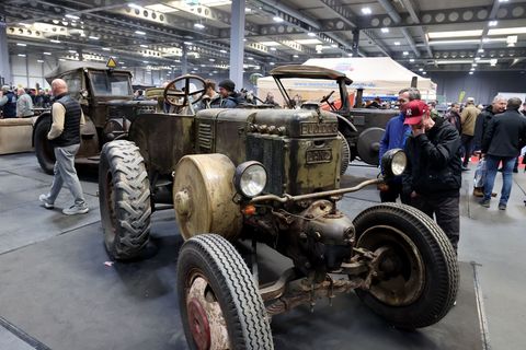 Hochglanzautos stehen auf der Messe neben alten Traktoren. Foto: Bodo Schackow/dpa
