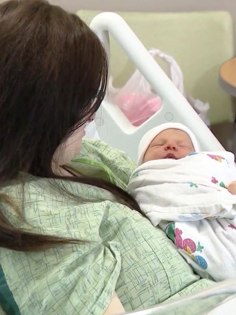 Frau mit Neugeborenem im Krankenhaus