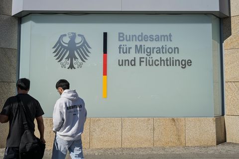 Zwei Menschen vor dem Bundesamt für Migration und Flüchtlinge (Bamf) in Berlin (Archivbild)