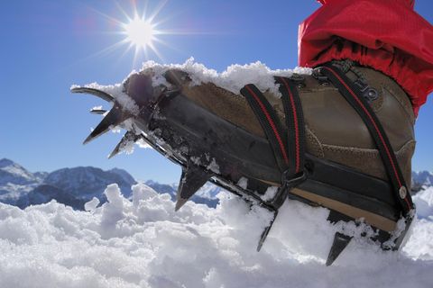 Hiker in ice climbing crampons, low section, close-up