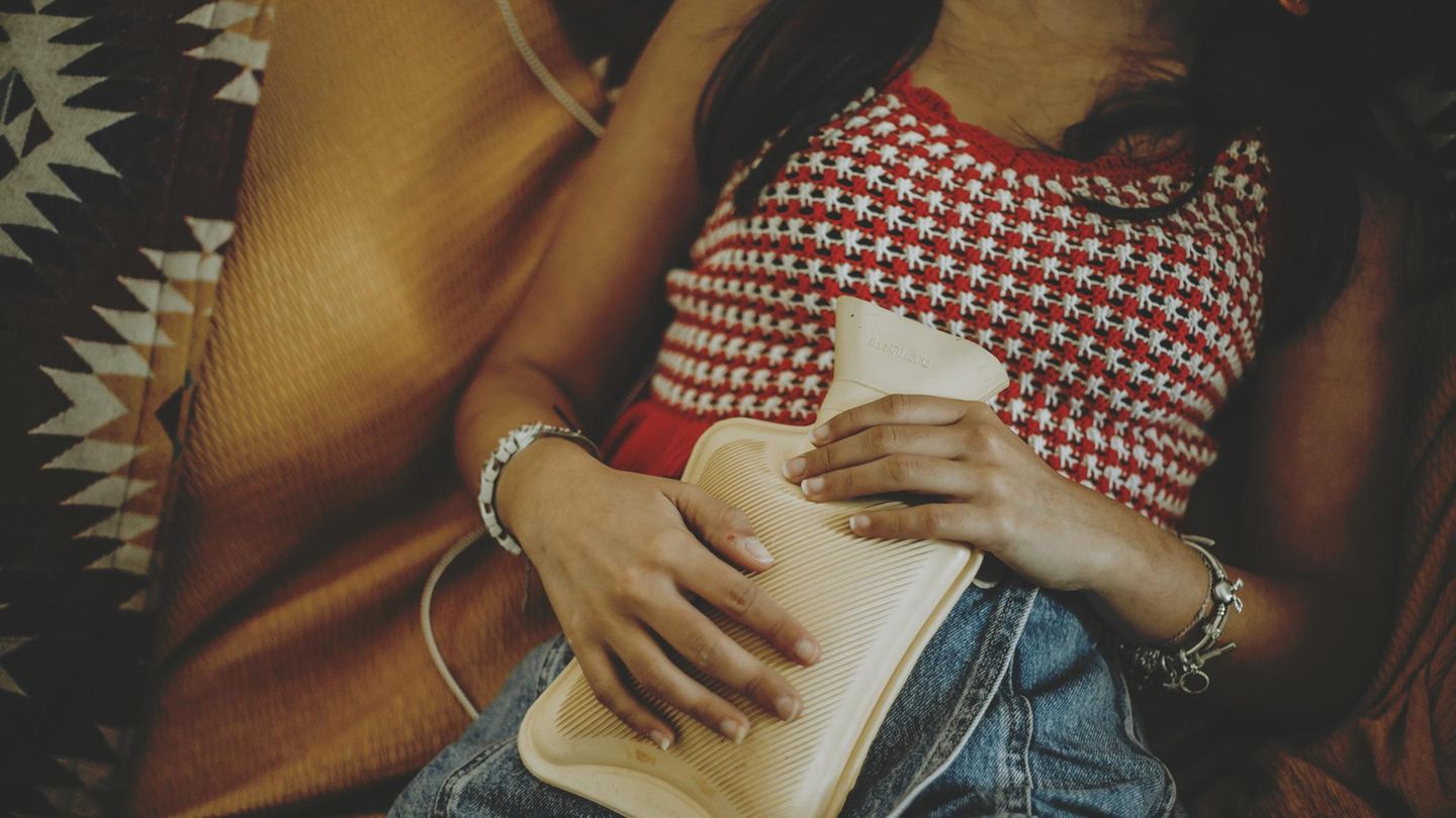 Toasted-Skin-Syndrom: Frau mit Wärmflasche auf dem Bauch