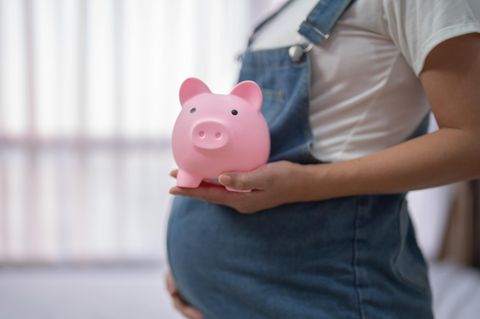 Elterngeld: Schwangerer Bauch mit Sparschwein