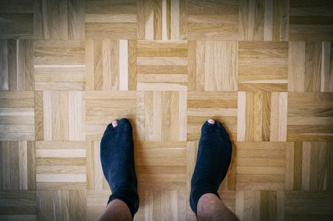 Deal-News-Socken: Ein Mann trägt schwarze Socken mit Löchern
