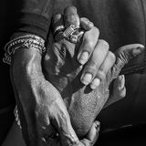 Zwei Hände halten einander eindrucksvoll in der schwarz-weiß Fotografie
