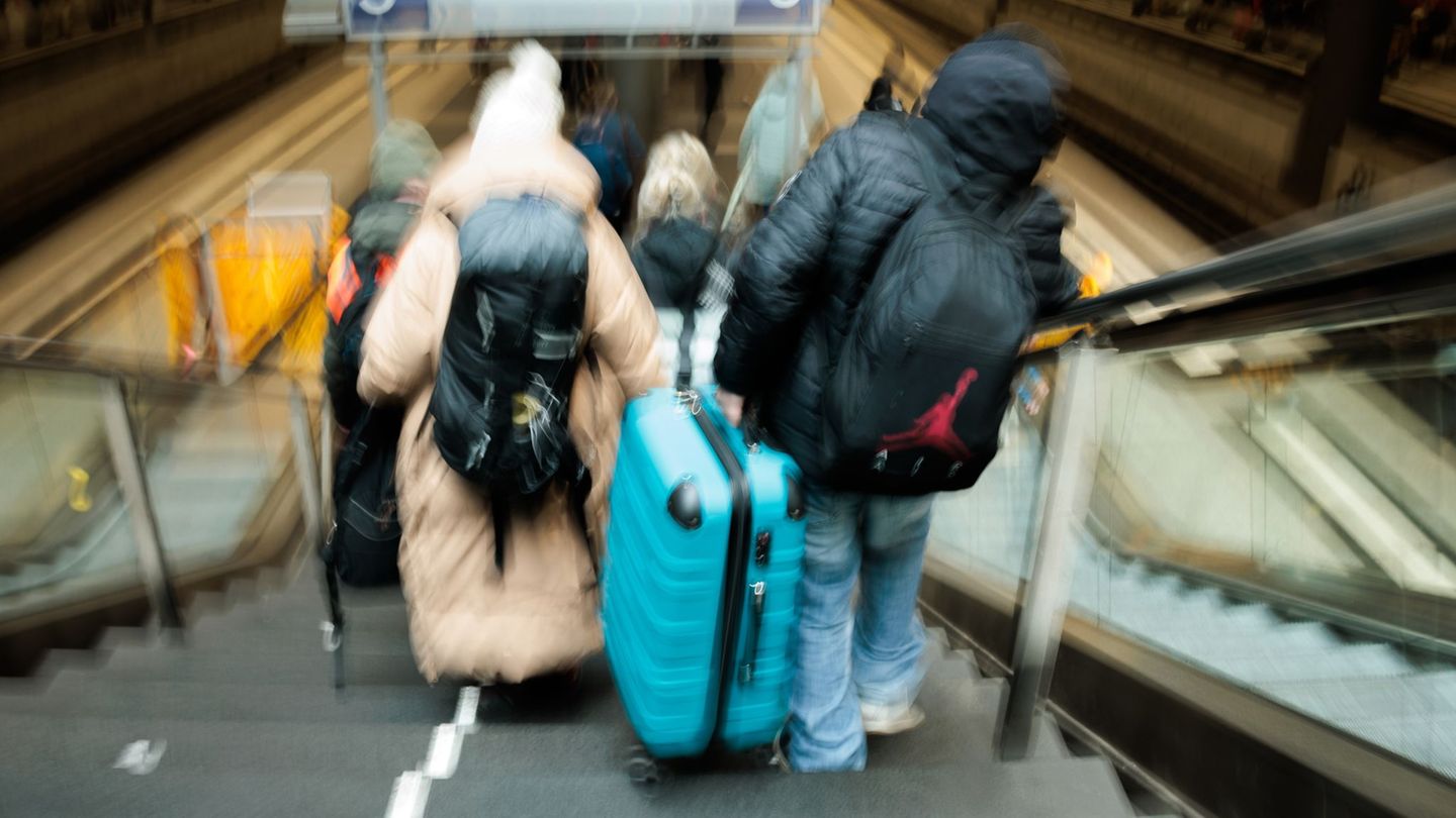 Reisende tragen auf dem Berliner Hauptbahnhof neben den gesperrten Rolltreppen große Koffer die Treppen hinab zum Bahnsteig. Fot
