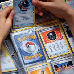 Eine Person hält Pokémon-Karten in der Hand