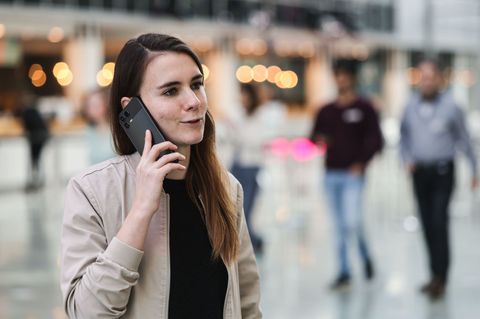 Die für KI zuständige Telekom-Mitarbeiterin Lena Drubel führt bei einer Testvorführung des KI-Assistenten ein Handytelefonat. Fo